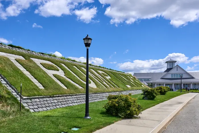 A grassy hill with the name "Trump Links" etched out in light colored bricks.